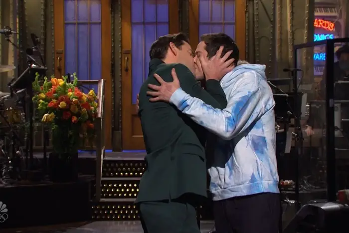 John Krasinksi and Pete Davidson kissing during the SNL monologue